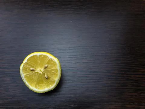 Half a lemon on a wood background Stock Photos