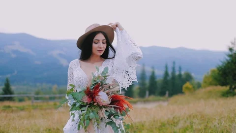 Half-length portrait of a bride in hat outdoors. Beautiful mysterious woman Stock-Footage 124705653