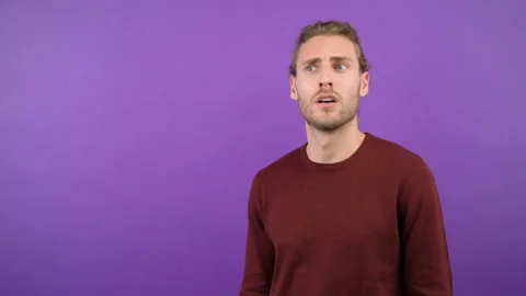Half-length portrait of a shocked man looking at the camera. Young long-haired Stock-Footage 145368980