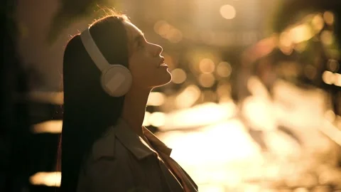 Half length profile portrait of young handsome caucasian woman listening music Stock Footage 231878788