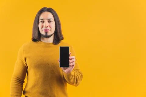 Half length shot of optimistic man holding his smartphone with mock up black Stock Photos
