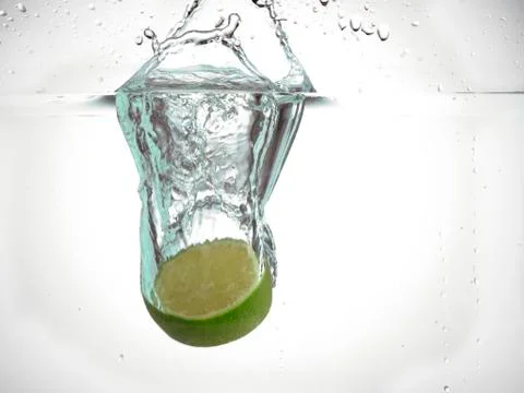 Half lime dropped in water Stock Photos