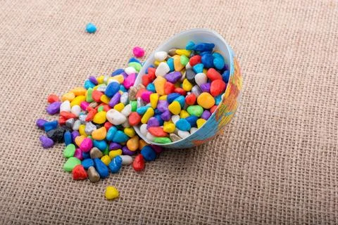 Half a little model globe full of colorful pebbles Stockfoto's
