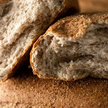 Half loaf of whole wheat bread. Healthy grain bread. Fresh baked goods concept Stock Photos