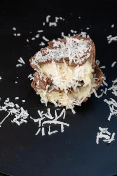 Half a milk chocolate Easter egg with coconut candy filling vertical. Stock Photos