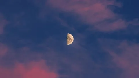 Half moon appearance evening twilight sky with wispy cloud formations. Celestial Stock Footage 344845051