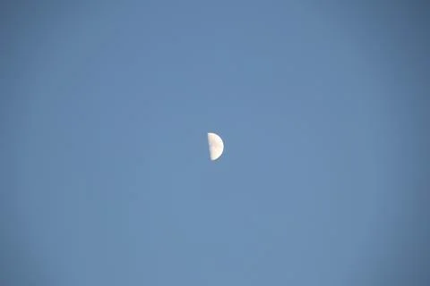 Half moon on a blue background copy space Stock Photos