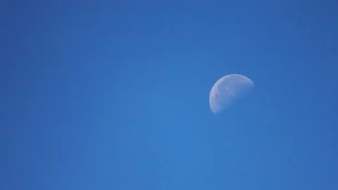 Half moon in blue sky 1 Stock Footage 130881649