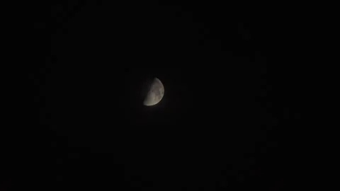 Half-moon with blue sky during dusk. Telephoto view Stock Footage 284502109