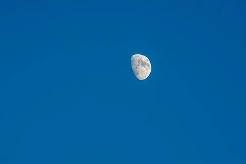 A half moon in a clear cloudless evening sky Foto stock