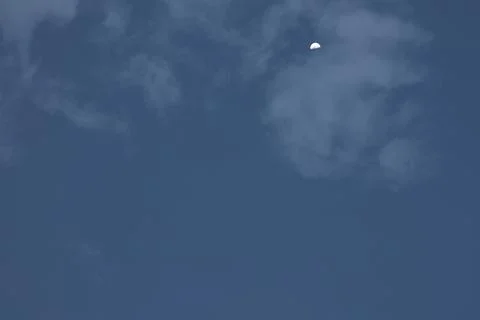 Half Moon in a Cloudy Blue Sky Foto stock