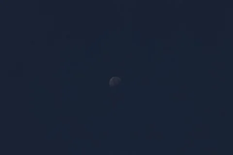 A half moon on a dark background Stock Photos