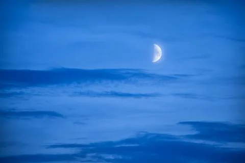 Half moon in dark sky Stock Photos