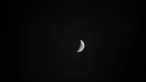 Half moon on early cloudy night with dark sky  Stock Footage 85747009