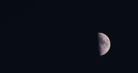 Half Moon over pitch black background, shadow &amp; light, astronomy, 4K Stock Footage 250412840
