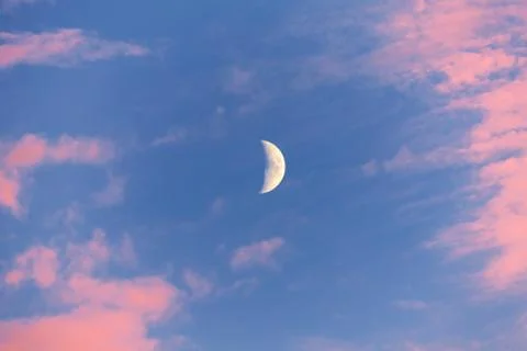 Half moon with red clouds Stock Photos