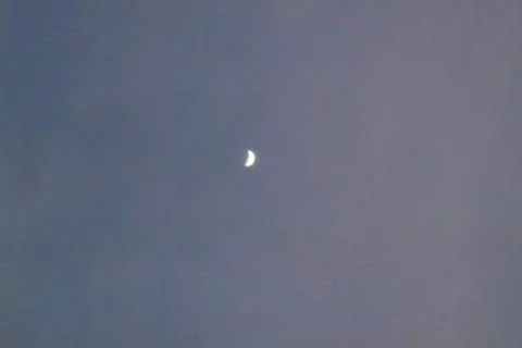 Half moon into the sky at evening time Stock Photos