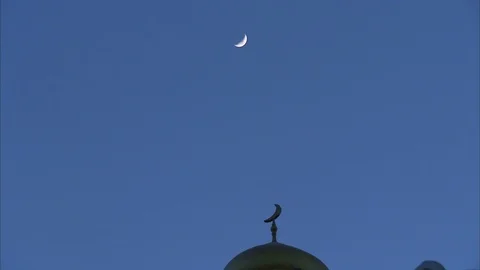 Half-moon in the sky over a mosque Stock Footage 88542296