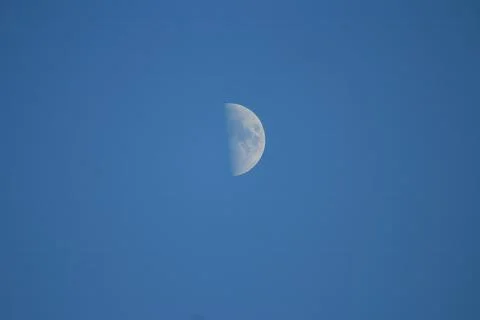 Half Moon Visible in Daytime Blue Sky with Copy Space Stock Photos