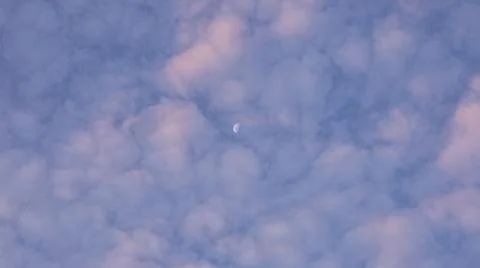 Half Moon Visible Through Clouds Stock Photos
