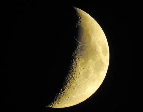 Half-moon with a yellow glow. Stock Photos