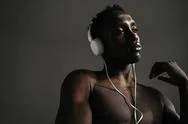 Half-Naked African American Sportsman Using Headphones While Working Out Stock Photos