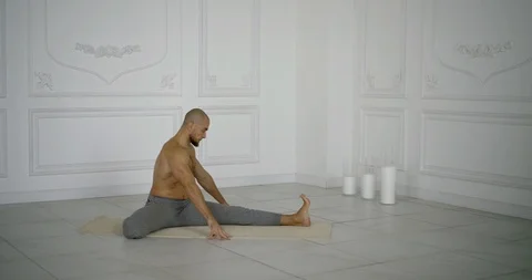 half-naked muscular man is stretching le... | Stock Video | Pond5