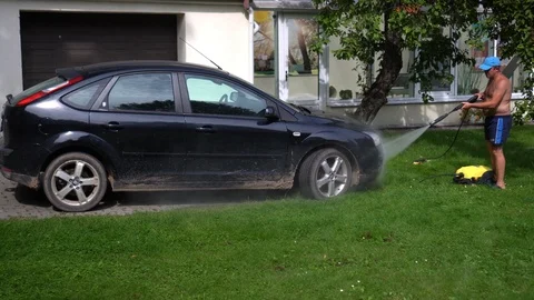 Half nude man washing his car with water... | Stock Video | Pond5