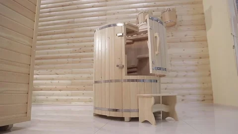 A half open cedar phyto-barrel with stool next to it in a room of the spa salon Stock Footage 154002689