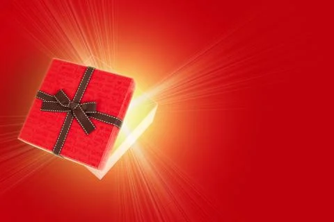 Half open gift box with light inside out Stock Photos