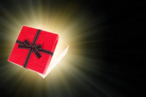 Half open gift box with light inside out Stock Photos