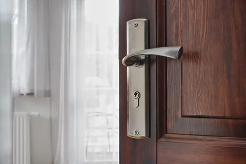 Half opened door into the modern cozy home interior Photos