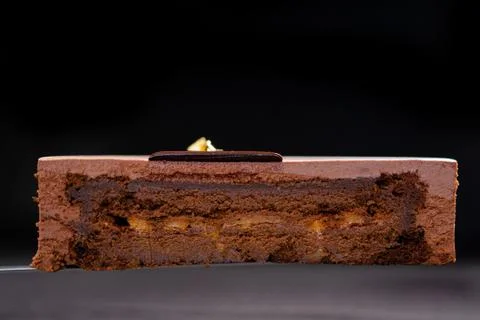 Half or slice of chocolate mousse cake isolated on black background. Stock Photos