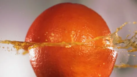 Half Orange falling and splashing on white kitchen background. Food levitation Stock Footage 199017707