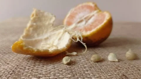 A half of orange fruit on the brown table Stock Footage 150523072