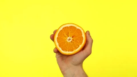 Half an orange in hand Stock Footage 153535935