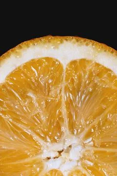 Half an orange levitating on black background. Stock-Fotos