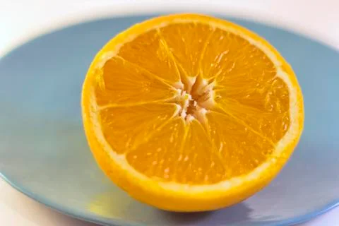 Half Orange on Plate Stock Photos