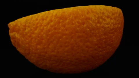 Half Of The Orange Rotation On Black Background Stock Footage 131800305
