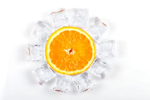 Half orange surrounded by ice cubes melting isolated Stock Photos
