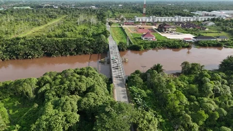 Half Orbit Aerial View of Bridge Crossing Kapuas River with Tropical Forest Stock Footage 334170345