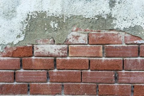 Half painted brick wall. Aged brick wall with dropped last layer of cement an Stock Photos
