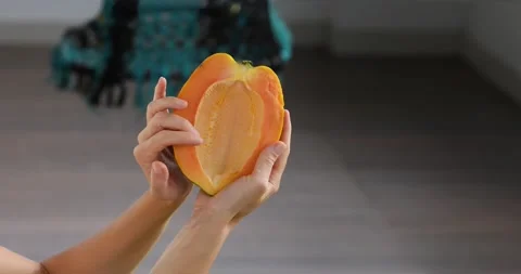 Half of papaya fruit on hand. Fragrant tropical fruit pulp. Sweet fresh papaw, Stock Footage 224414580