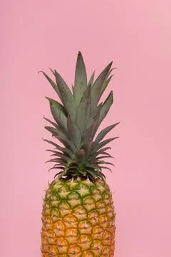 Half part of a pineapple on a pink background Stock Photos