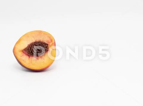 Half peach isolate with pits Stock Photos