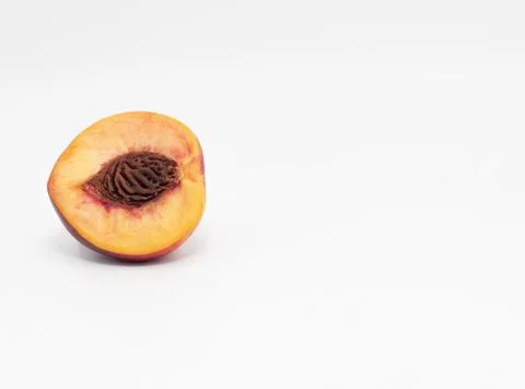 Half peach isolate with pits Stock Photos