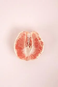 Half peeled grapefruit Stock Photos