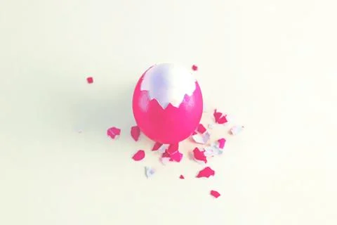 Half-peeled pink Easter egg with husks scattered on the surface Stock Photos