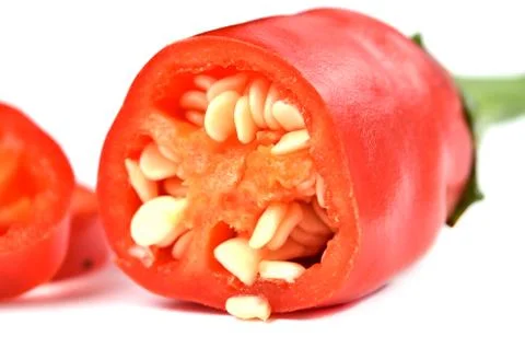 Half pieced chilli pepper with seeds isolated on white background. Stock Photos