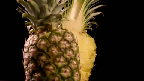 Half of pineapple slowly falls. Fresh sliced pineapple on black background. Vídeos de archivo 149996839
